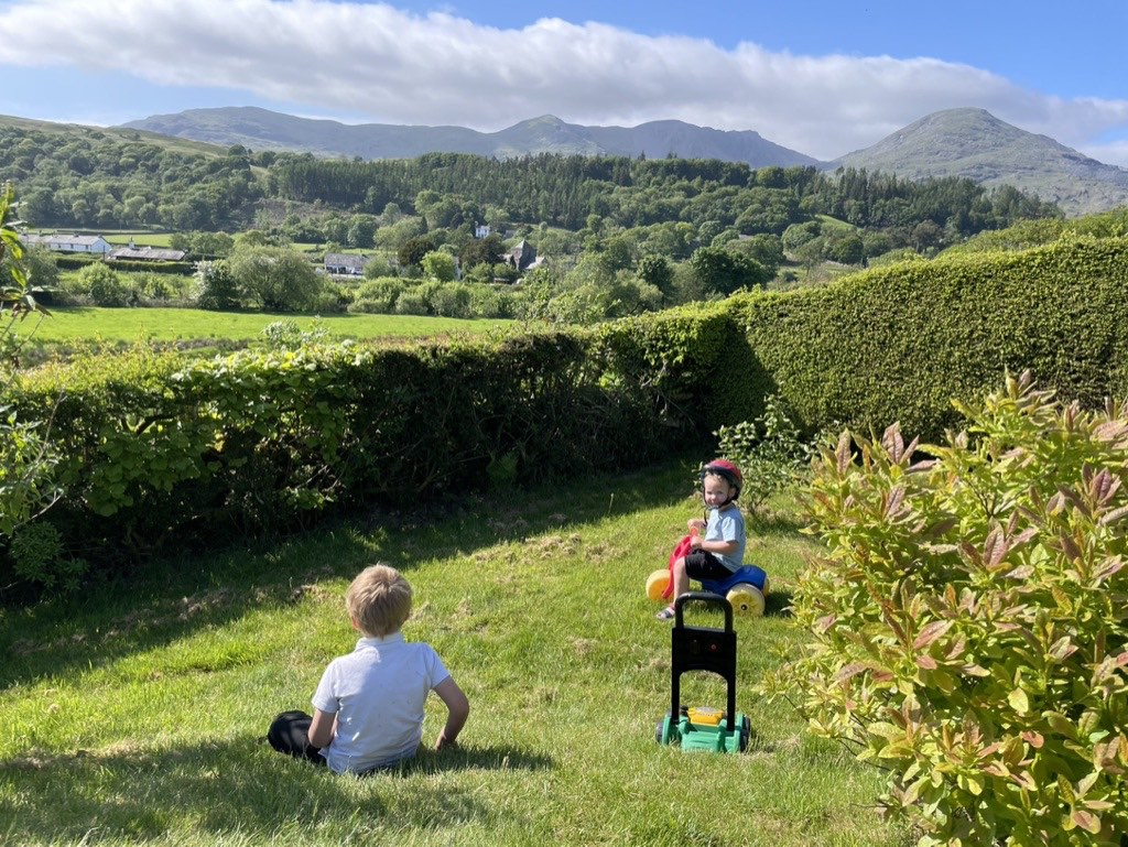 Our kids in the garden at Hollace with Coniston Old Man in the background 